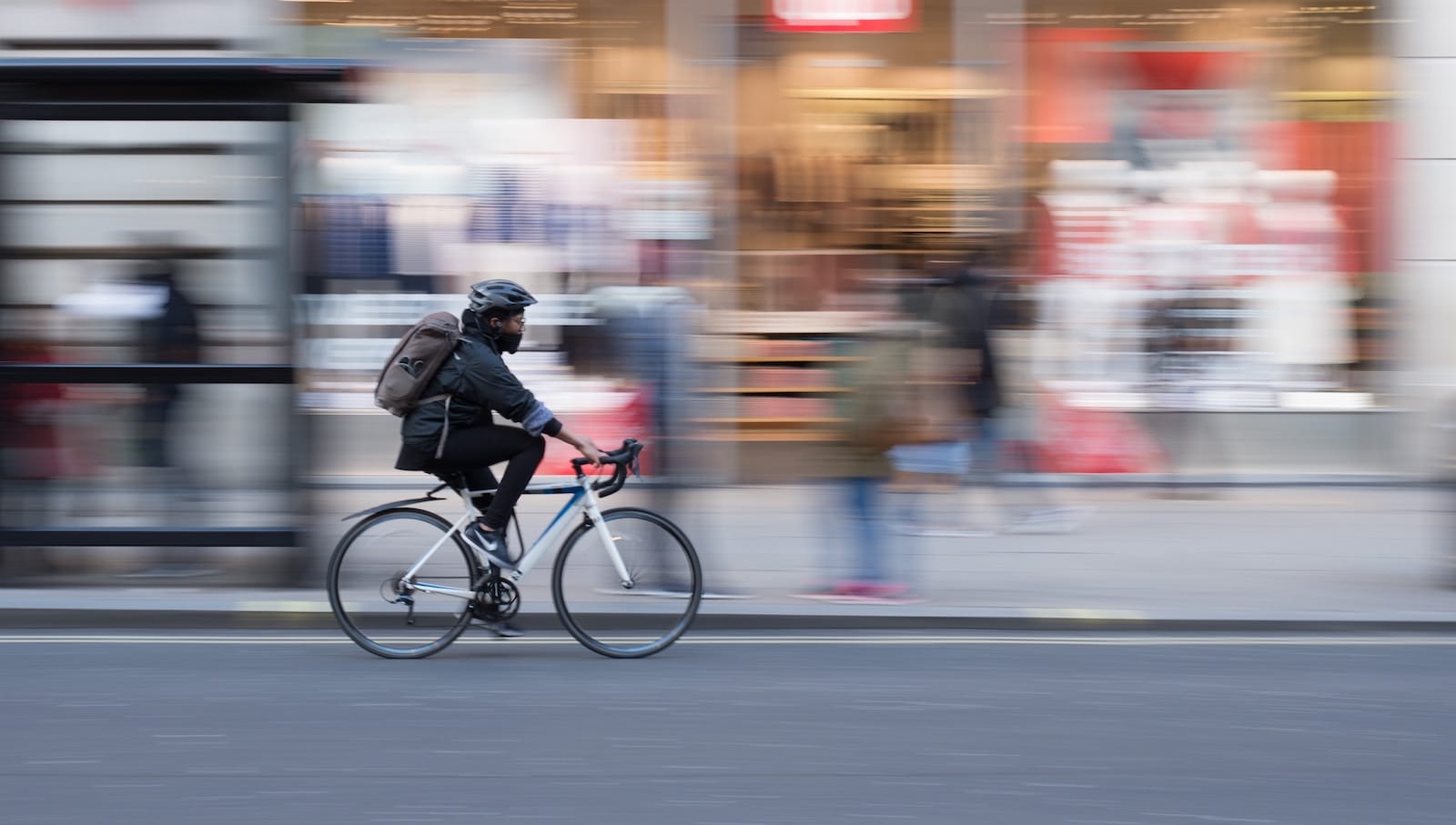 person bicycling in city blurred