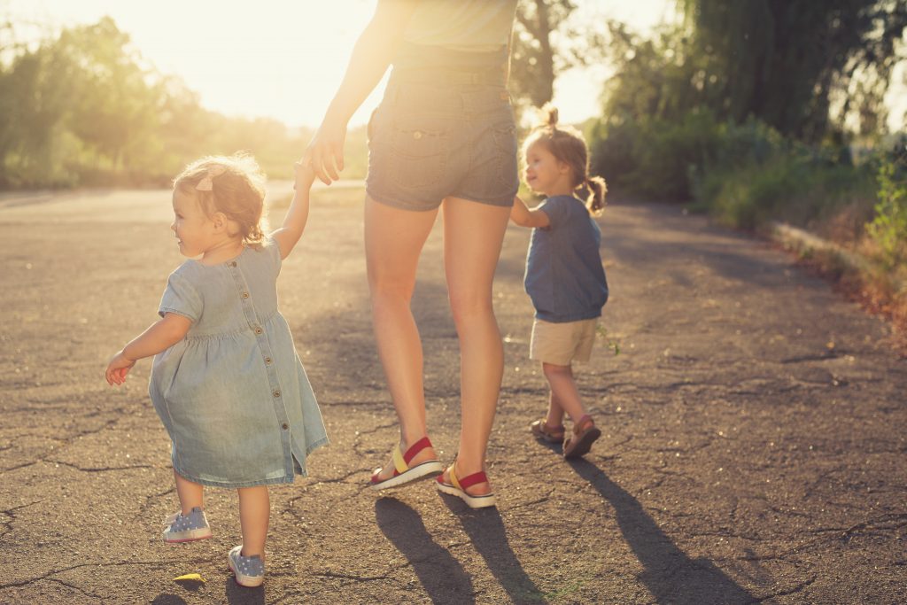 Mother walk with two children